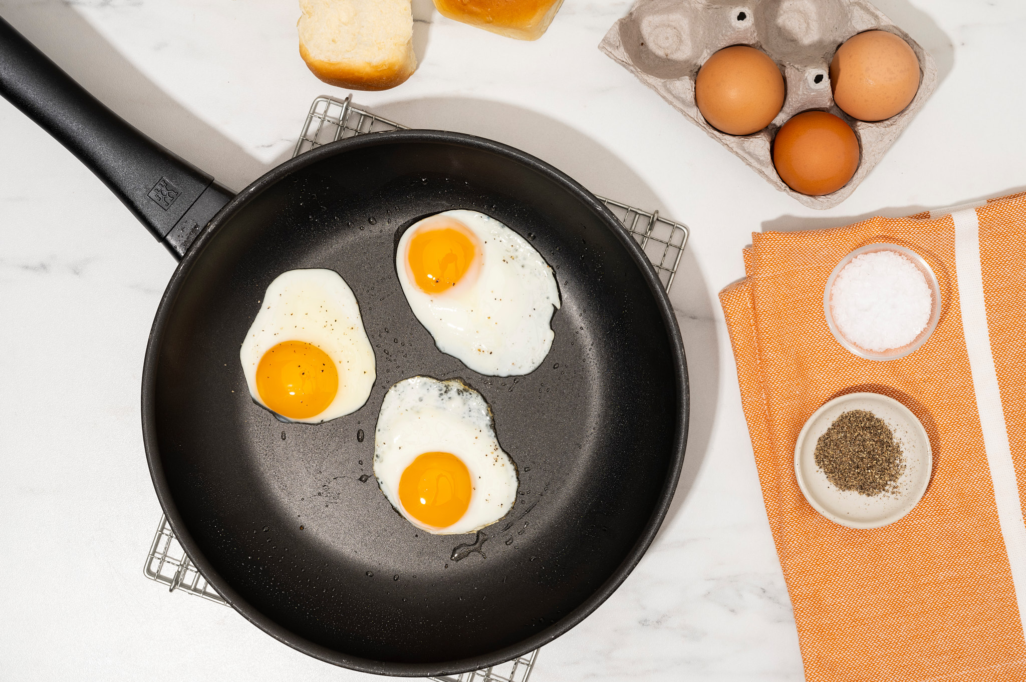 Cook eggs over easy on the stove