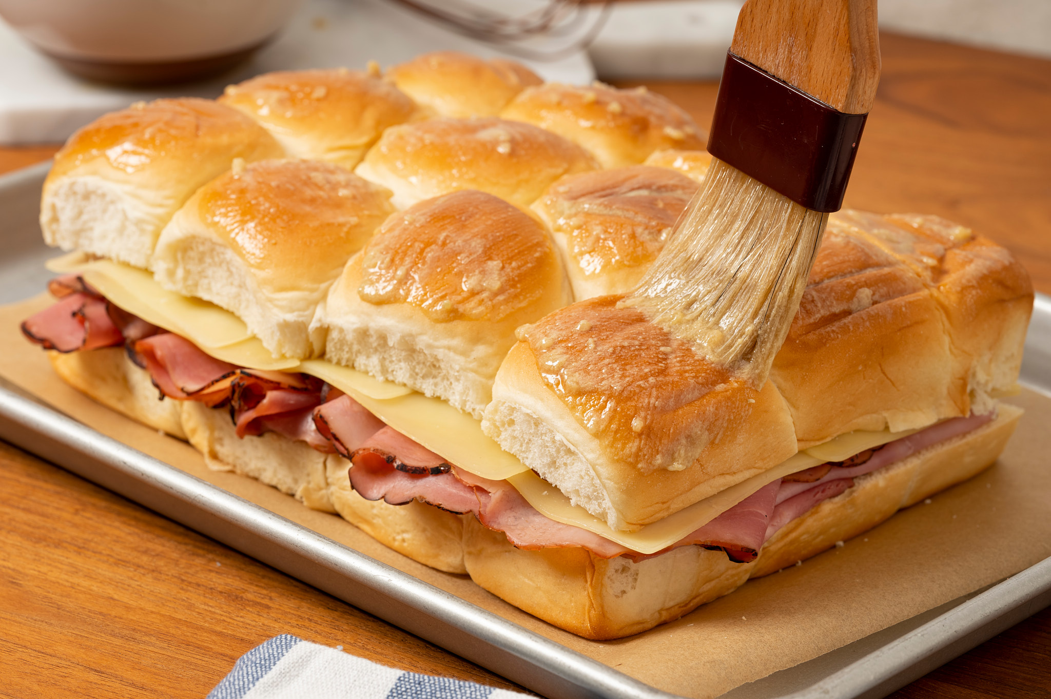 Drizzle butter mixture over the top of the Mini Baked Ham Sandwiches