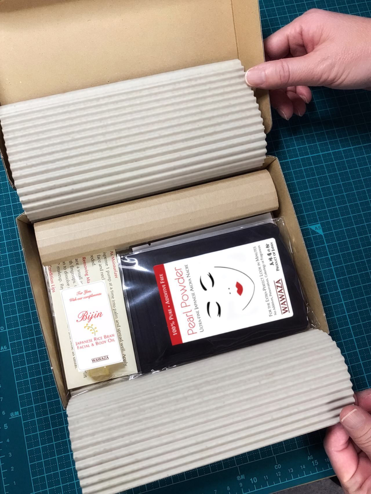 Eco-responsible packaging demonstration showing cardboard box with recycled paper fillers