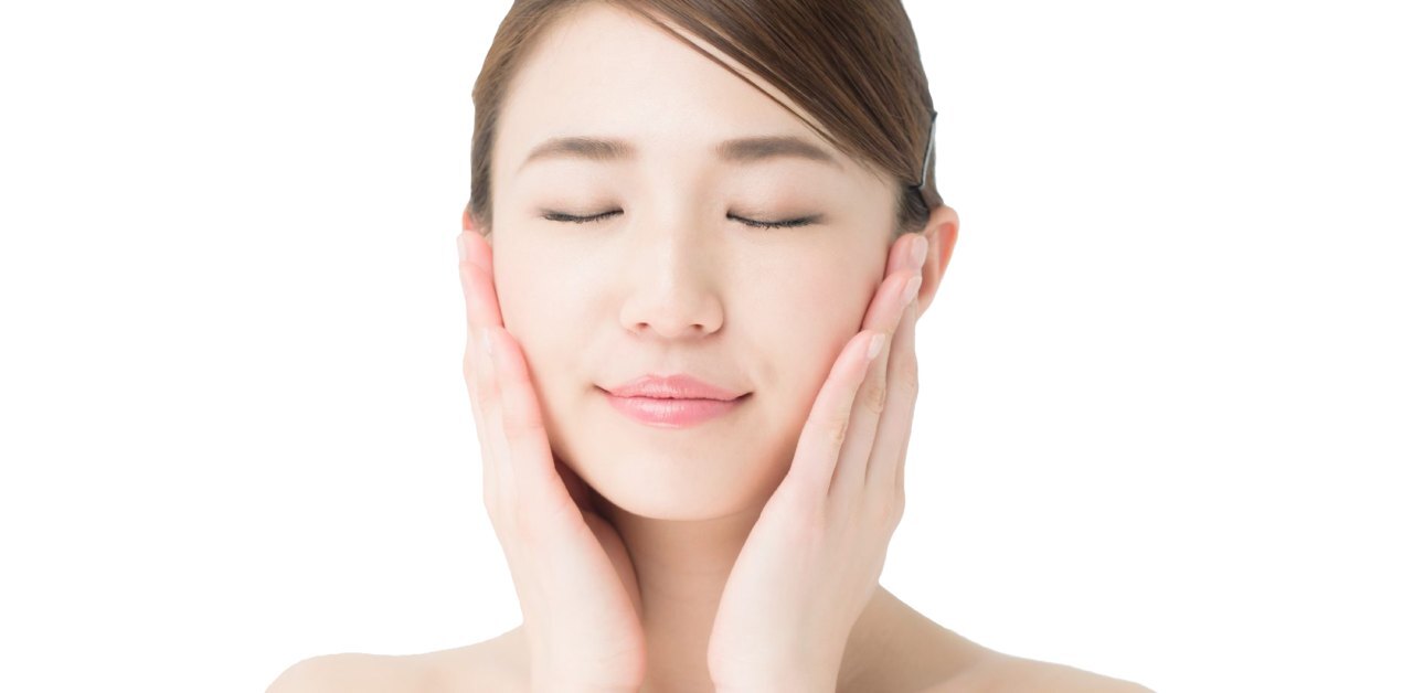 Japanese woman moisturizing her face