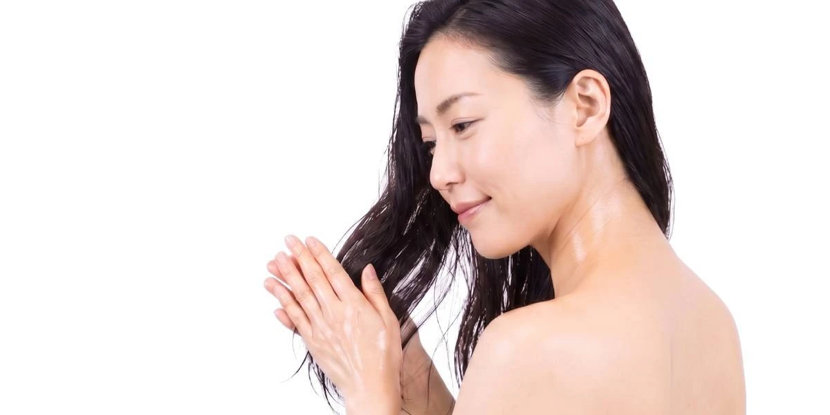 Japanese woman caring for her hair with traditional camellia oil