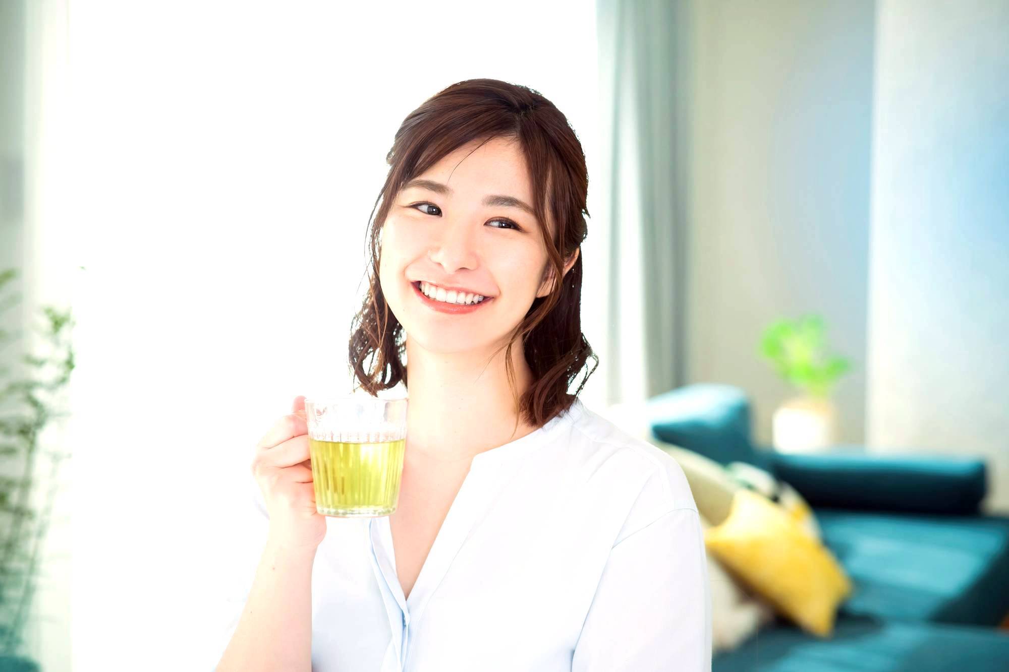 Japanese woman enjoying a cup of herbal tea in a Japanese home