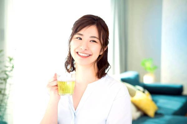 Japanese woman drinking a cup of herbal tea
