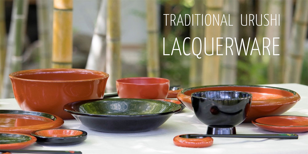 A set of traditional Urushi lacquerware from southern Japan on a table against a bamboo background