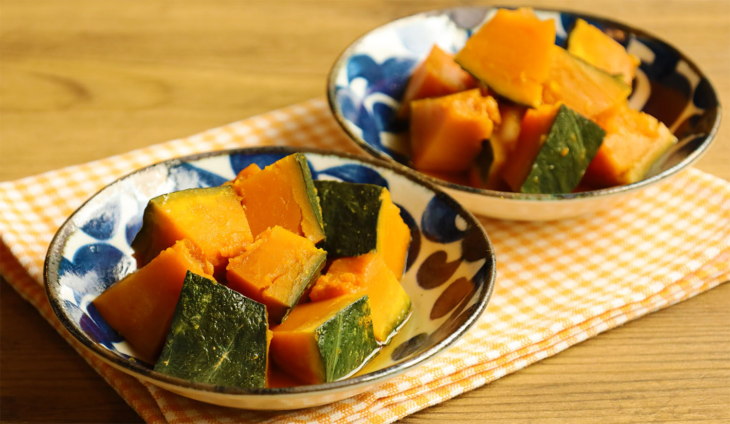 Two bowls of Kabocha Nimono, a traditional Japanese simmered pumpkin dish