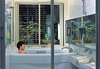 View of a room with a woman soaking in a bathtub