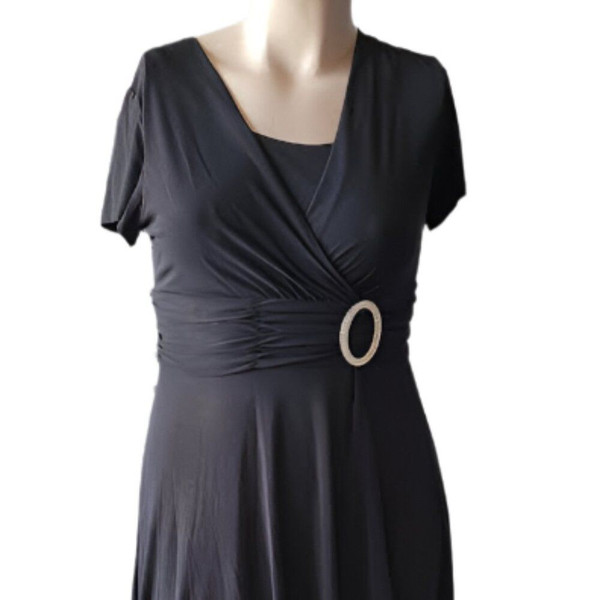 Elegant and timeless, this R&M Richards black faux wrap dress in size 14 features a flattering silhouette with a decorative ring detail at the waist. Perfect for special occasions or evening wear.