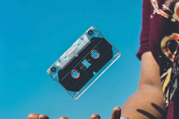 cassette falling into the hand of a man