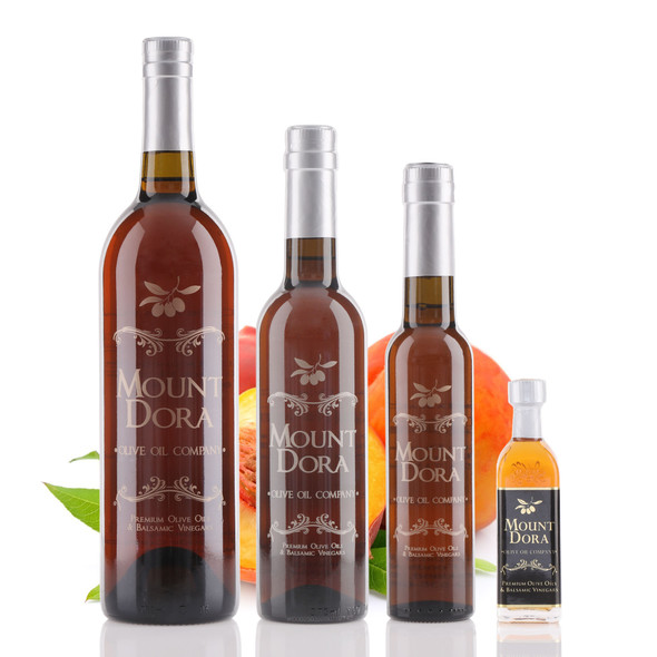 Four different size bottles of Mount Dora Olive Oil Company Ripe Peach 
White Balsamic Vinegar.