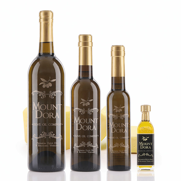 Four different size bottles of Mount Dora Butter Infused Olive Oil