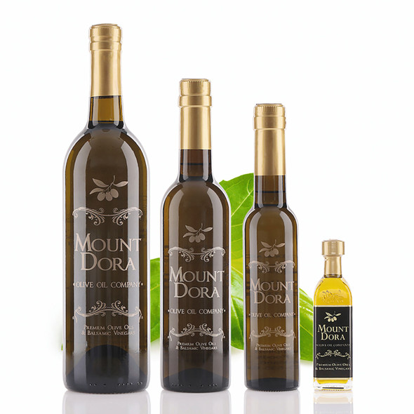 Four different size bottles of Mount Dora Basil Infused Olive Oil