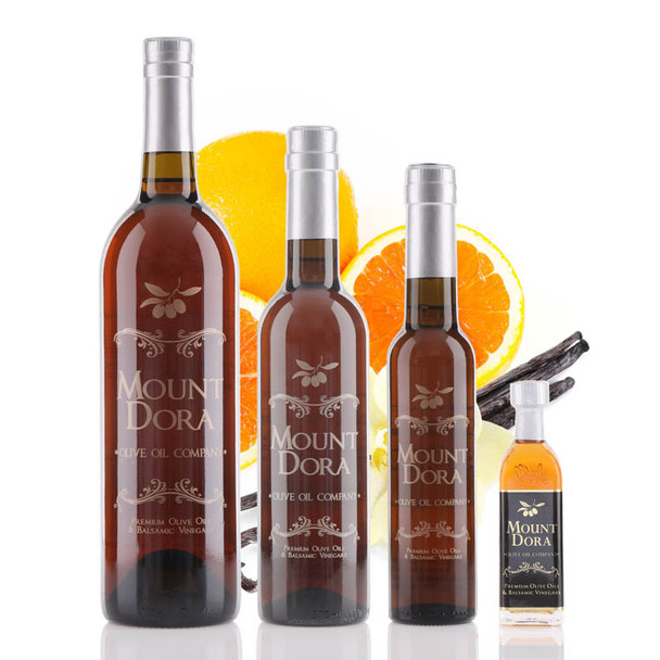 Four different size bottles of Mount Dora Olive Oil Company Cara-Cara Orange Vanilla White Balsamic Vinegar