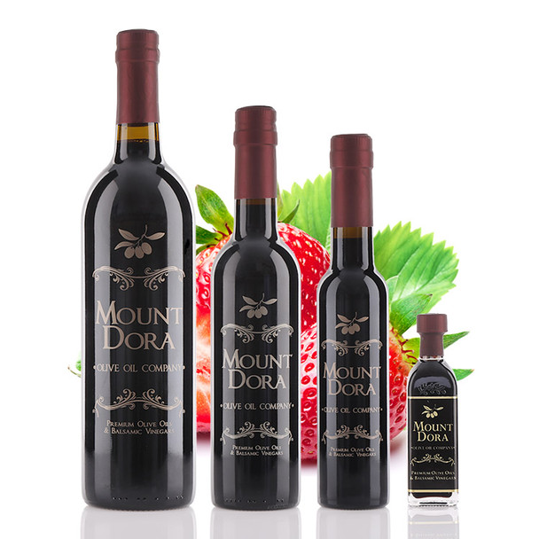 Four different size bottles of Mount Dora Olive Oil Company Strawberry Dark Balsamic Vinegar