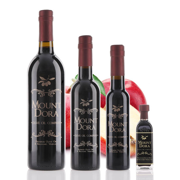 Four different size bottles of Mount Dora Olive Oil Company Red Apple Dark Balsamic Vinegar