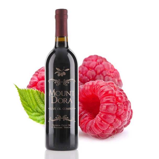 Four different size bottles of Mount Dora Olive Oil Company Raspberry Dark Balsamic Vinegar.