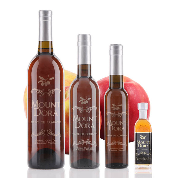 Four different size bottles of Mount Dora Olive Oil Company Gravenstein Apple White Balsamic Vinegar.