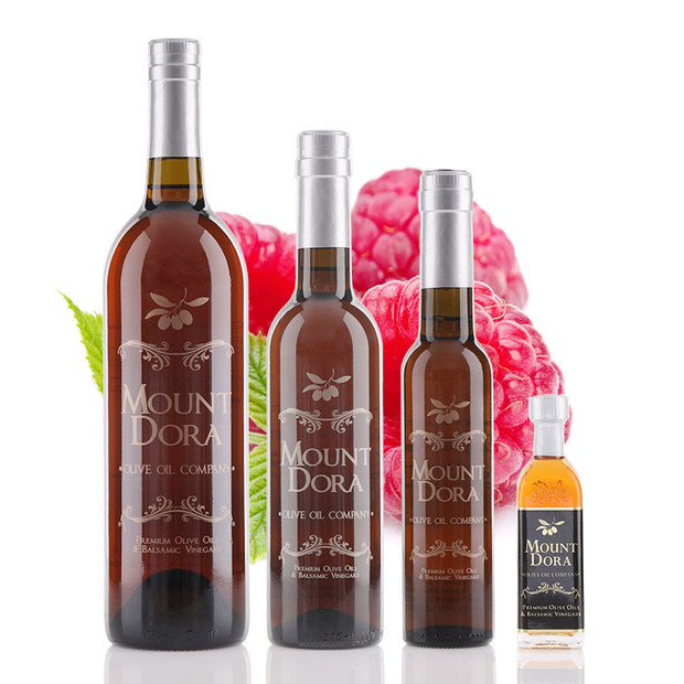 Four different size bottles of Mount Dora Olive Oil Cascadian Wild Raspberry White Balsamic Vinegar
