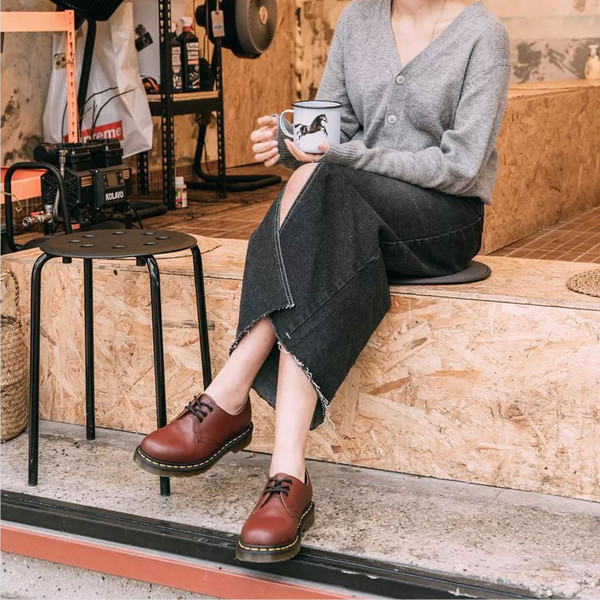 Woman wearing Dr Martens 1461 Women's Mod Cherry Red Leather Shoes