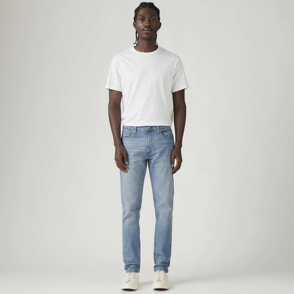 Model Wearing Levis 512 Men's Retro Slim Tapered Denim Jeans in Pelican Rust Wearing White T-shirt