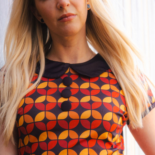 Woman wearing madcap england womens dollierocker circle pattern 60s mod dress black coffee