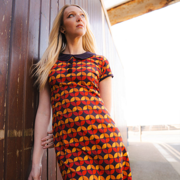 Woman wearing madcap england womens dollierocker circle pattern 60s mod dress black coffee