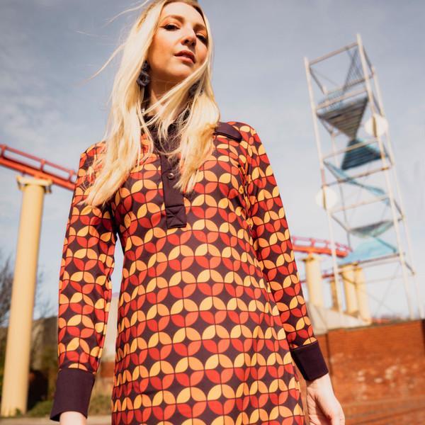 Woman wearing madcap england womens daydream 70s circle print long sleeve dress dark purple red orange