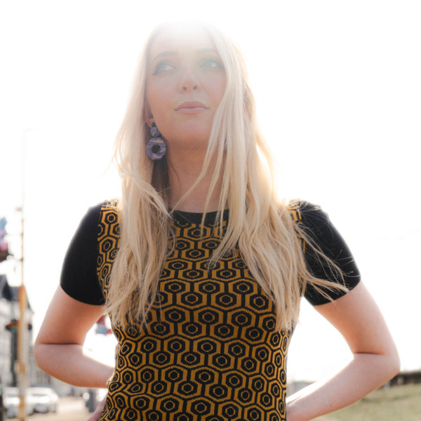 Woman wearing Madcap England Overlook Honeycomb Knitted Dress in Black and Golden Glow
