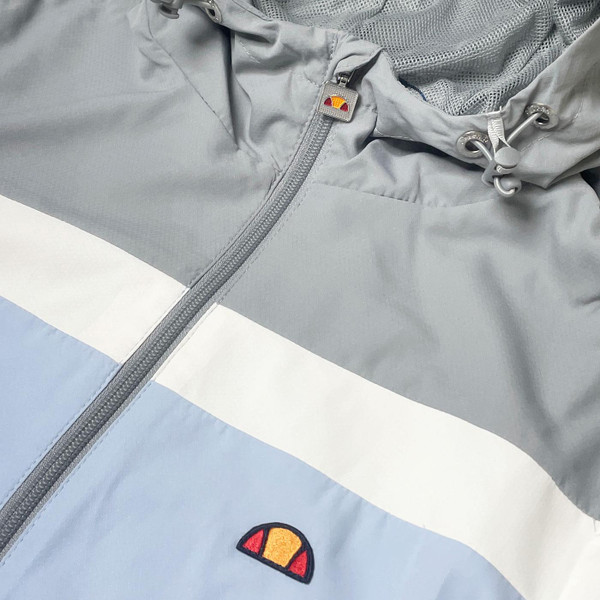 Ellesse Dune Retro Hooded Windbreaker Jacket in Light Blue Close Up 2