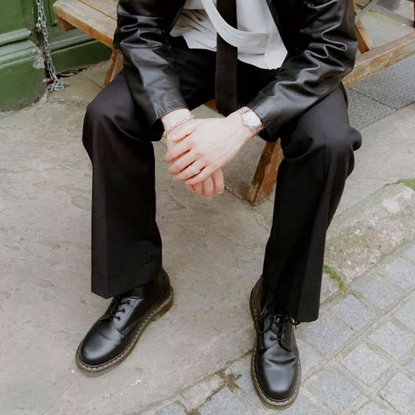 Man wears Dr Martens Mens 101 Smooth Leather 6-Eyelet Lace up Boots in Black