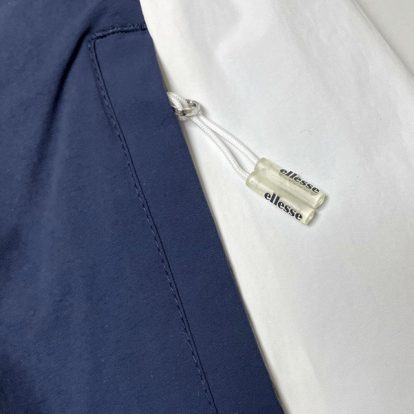 Close up of zip pocket on Ellesse mens Gandini Live Forever Festival jacket in Navy