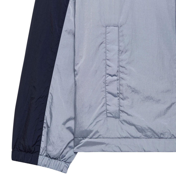 Close up on pocket and sleeve cuff of Weekend Offender Parissa Windbreaker Jacket in Navy/Blue Shadow JK3A43