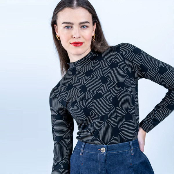 Woman wearing Mademoiselle Yeye Roll With It Retro 70s Soul Print Turtleneck Top in Black 52214