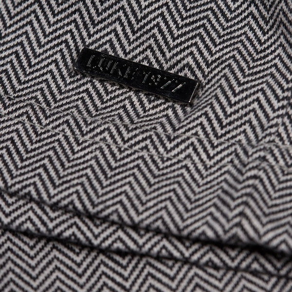 Luke Albaicin Men's Retro Herringbone T-shirt in Black and Grey Close up of fabric and badge