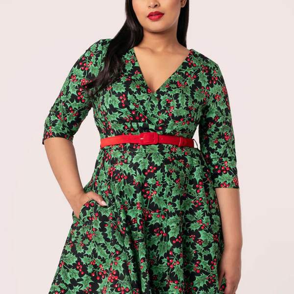 Close up on neckline and half length sleeve on Hell Bunny Nicole Christmas Holly Print 50s Doll Dress in Black and Green