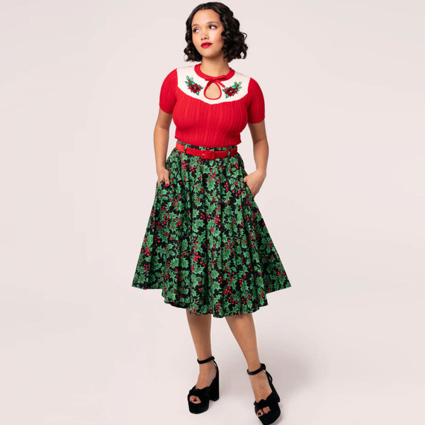 Full length of woman wearing Hell Bunny Poinsettia Retro 50s Cable Knit Short Sleeve Top in Red