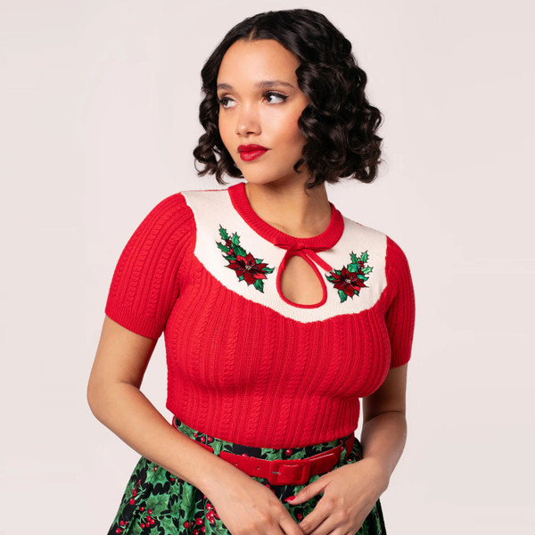 Women wears Hell Bunny Poinsettia Retro 50s Cable Knit Short Sleeve Top in Red