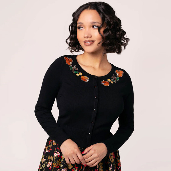 Woman wears Hell Bunny Chester Autumnal Embroidered 50s Style Cardigan in Black