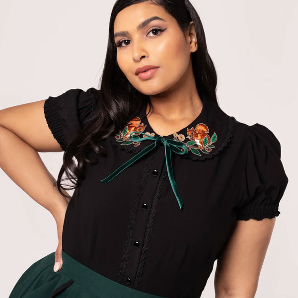 Woman wearing Hell Bunny Chester womens black button up blouse with Autumnal Squirrel Embroidery