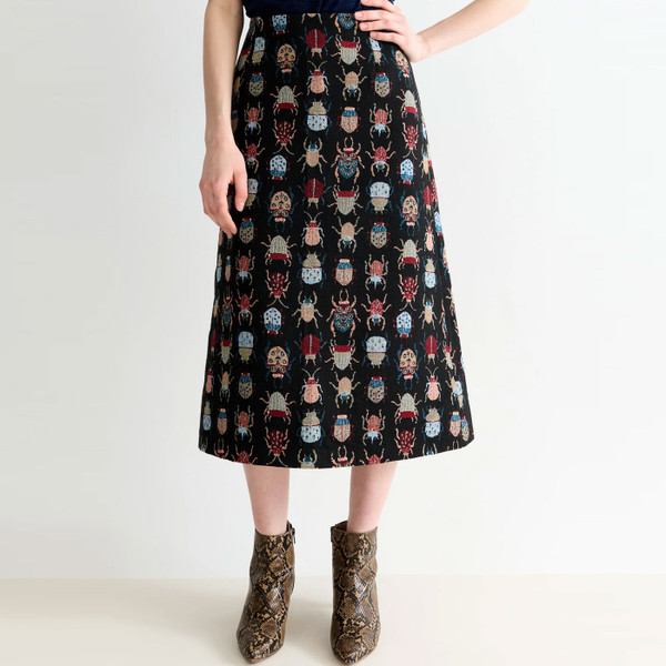 Model wears Louche London Buffy Beetlejuice A-Line Midi Skirt in Black
