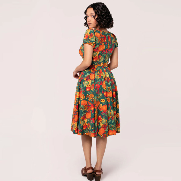 Back of model wearing Hell Bunny Pumpkin Patch Retro Flared Autumn Print Dress