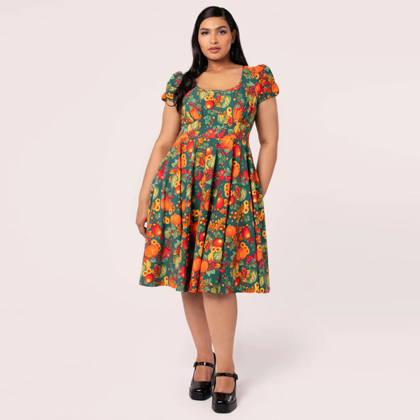 Woman wears Hell Bunny Pumpkin Patch Retro Flared Autumn Print Dress
