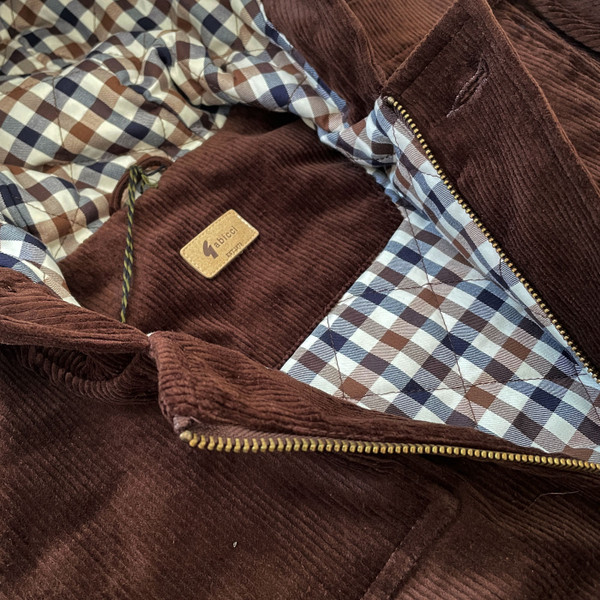 Close up on the lining on the Gabicci Vintage Chuck Retro 70s Men's Cord Duffle Coat in Clove Brown