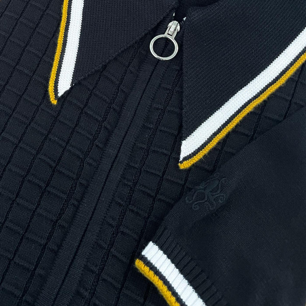 Madcap England Cannon Textured Grid Check Big Collar Ring Zip Knitted Polo Shirt in Black Close Up from Above Madcap England Cannon Textured Grid Check Big Collar Ring Zip Knitted Polo Shirt in Black Close Up from Above