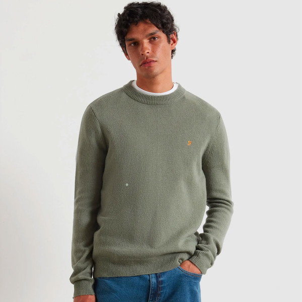 Man wears Farah Men's Maidstone Lambswool Knitted Sweater in Tarragon Green F4GFF060