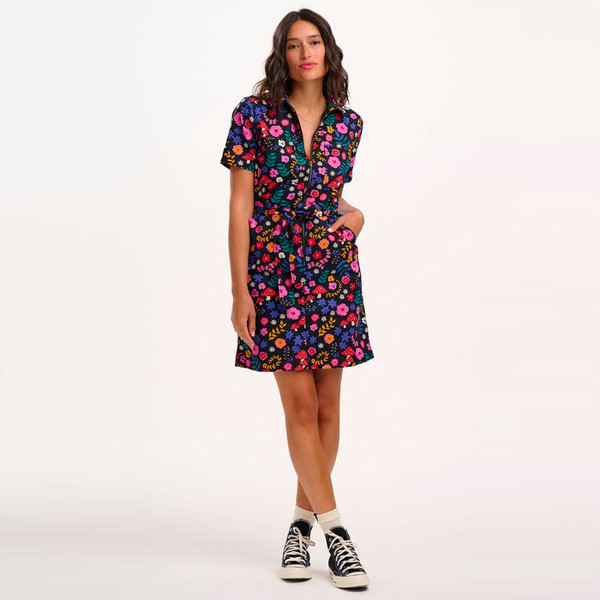 Woman wears Sugarhill Brighton Tasha Toadstool & Floral Print Mini Dress in Navy D1395