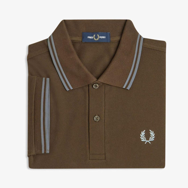 Fred Perry M3600 Twin Tipped Polo Shirt in Burnt Tobacco and Stockport Blue 49A pictured folded