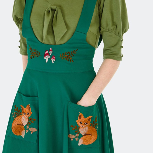Embroidered foxes on pockets of Voodoo Vixen Forest Fox Woodland Embroidered 50s Style Suspender Skirt in Green