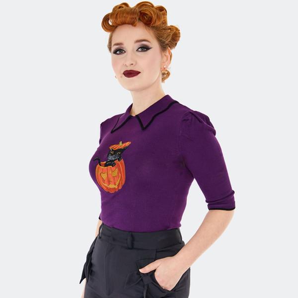 Side view of Voodoo Vixen Women's Knitted Halloween Black Cat and Pumpkin Collared Jumper in Purple
