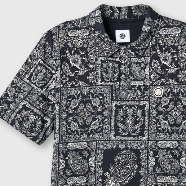Pretty Green Mod Patchwork Paisley Zip Polo Shirt in Black close up laid flat