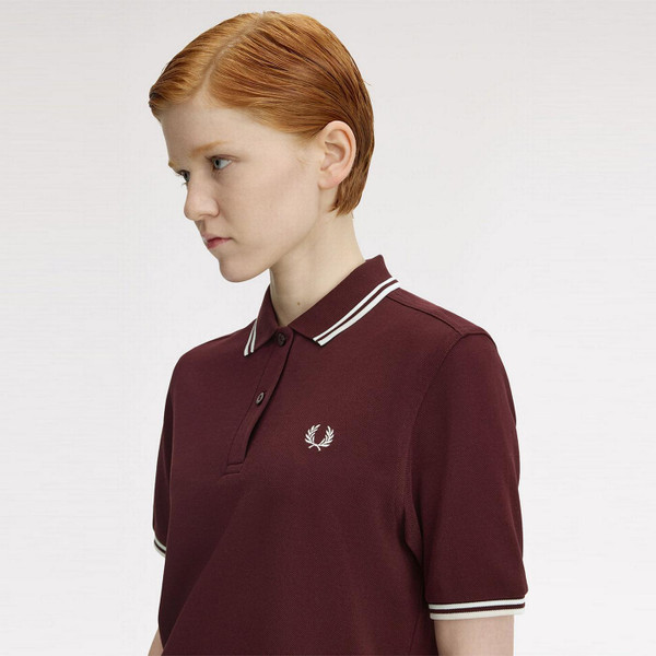 Model Wearing the Fred Perry Women's Twin Tipped Pique Polo Shirt in Oxblood an White G3600 597 Side View